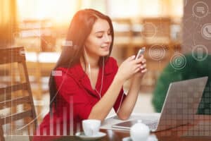 Young businesswoman using phone in coffee shop